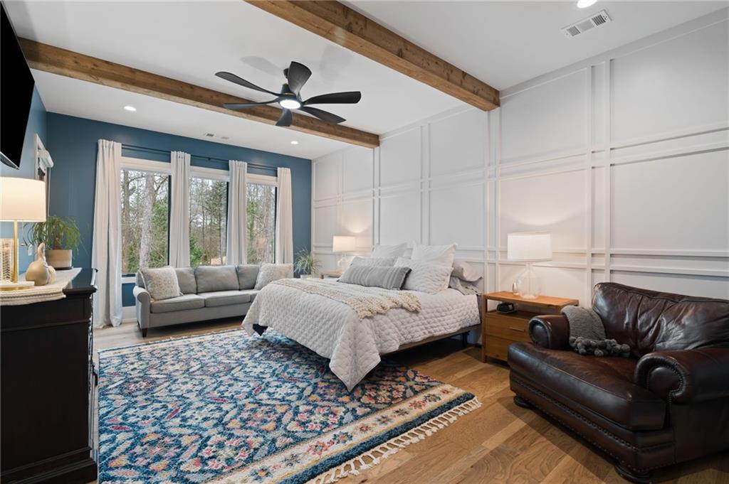 4226 South Berkeley Lake Road Northwest Berkeley Lake, GA 30096 - Photo 8 of 61 a spacious bedroom with a bed couch and a large window