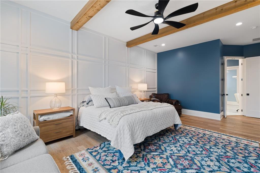 4226 South Berkeley Lake Road Northwest Berkeley Lake, GA 30096 - Photo 9 of 61 a bedroom with a bed and a chandelier