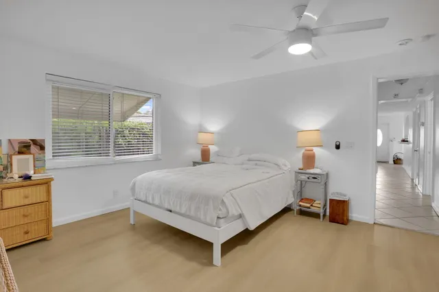 a spacious bedroom with a bed and a chandelier