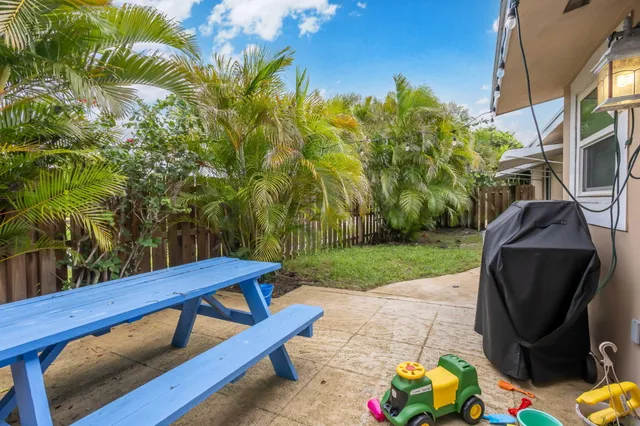 a view of a backyard with sitting area