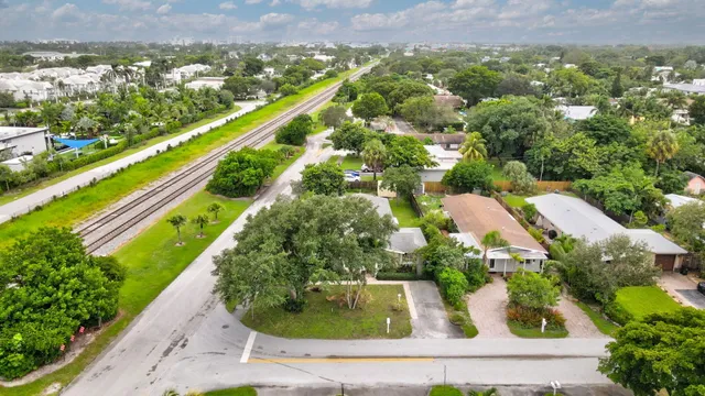 an aerial view of residential houses with outdoor space and street view