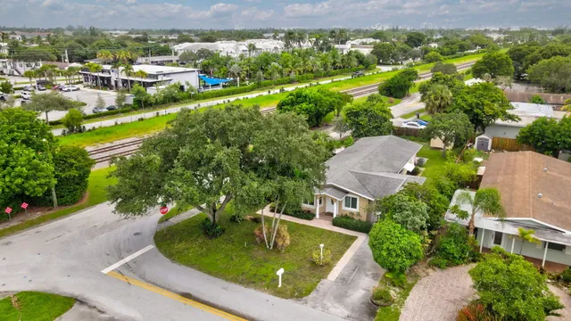 an aerial view of residential houses with outdoor space and swimming pool