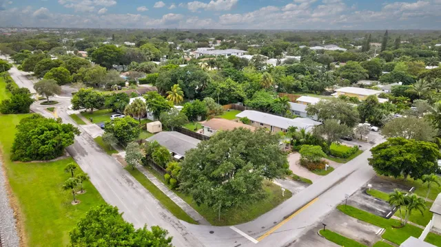 an aerial view of residential houses with outdoor space and street view
