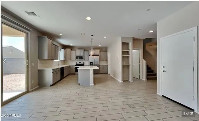 a kitchen with refrigerator cabinets and a sink