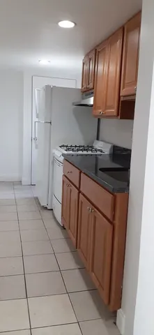 a kitchen with stainless steel appliances cabinets a sink and a stove top oven