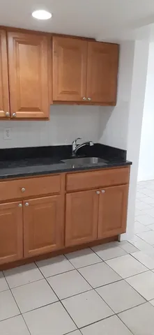 a kitchen with granite countertop cabinets and white appliances