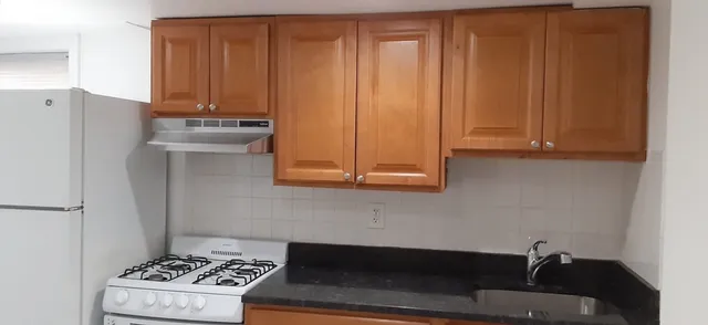 a room with a sink and a stove top oven