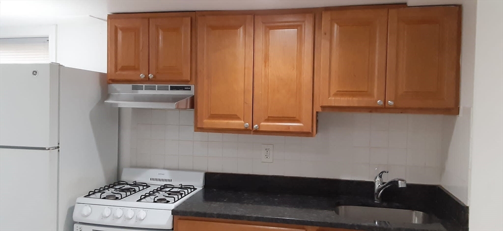 104 Beacon Street, Unit 1 Chelsea, MA 02150 - Photo 5 of 12 a room with a sink and a stove top oven