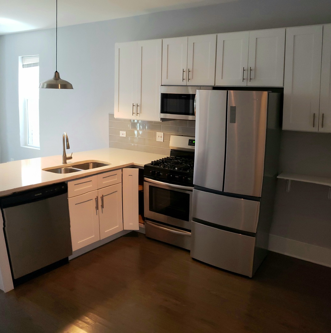 2030 West 21st Street Chicago, IL 60608 - Photo 8 of 19 a kitchen with stainless steel appliances a refrigerator sink and cabinets