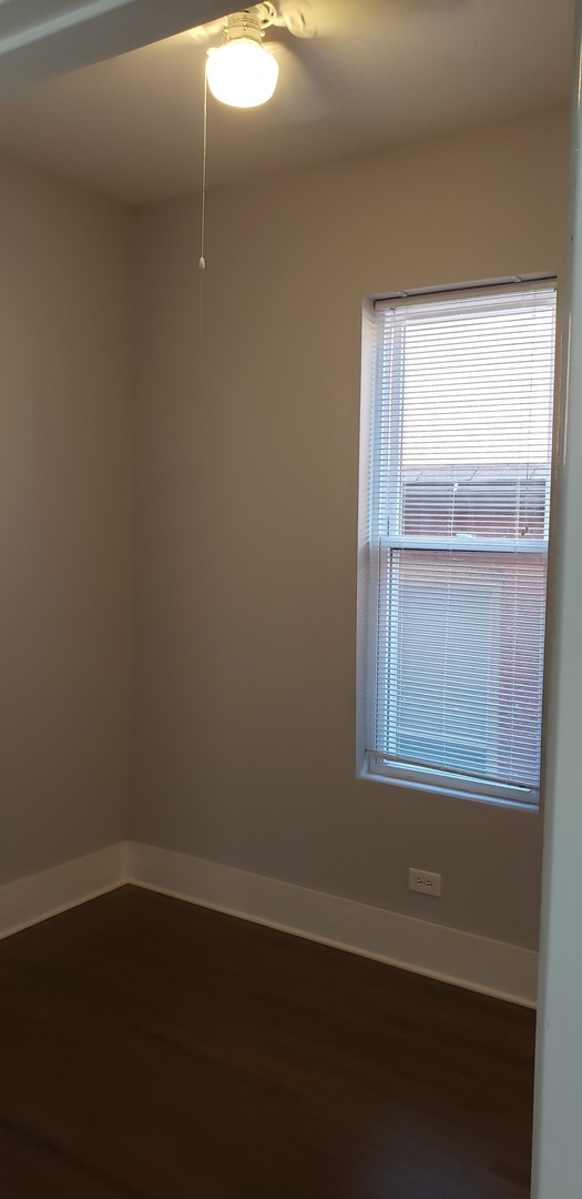 2030 West 21st Street Chicago, IL 60608 - Photo 9 of 19 a view of an empty room with wooden floor and a window