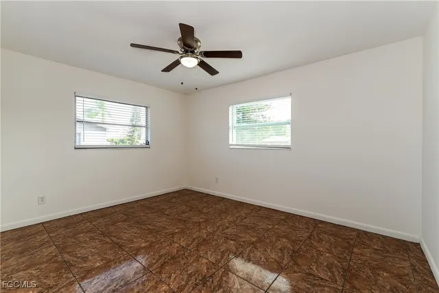 a view of a big room with wooden floor closet and windows