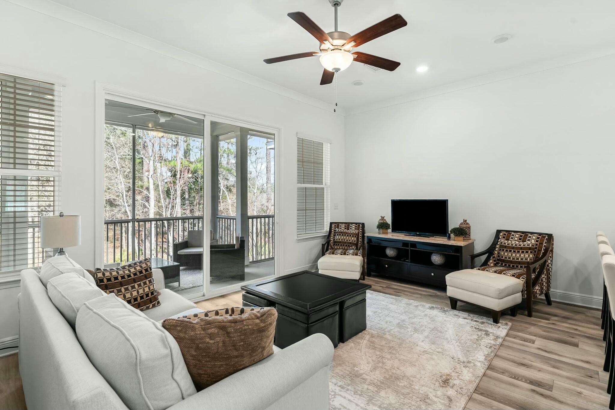 22 Kara Lake Drive Santa Rosa Beach, FL 32459 - Photo 13 of 44 a living room with furniture and a flat screen tv with wooden floor