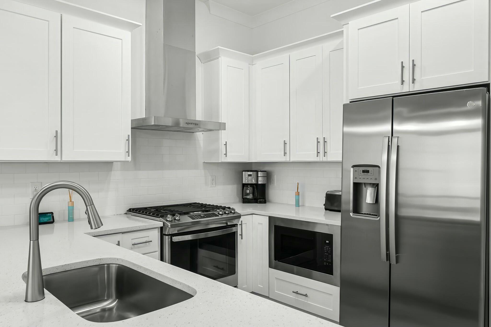 22 Kara Lake Drive Santa Rosa Beach, FL 32459 - Photo 17 of 44 a kitchen with white cabinets and stainless steel appliances