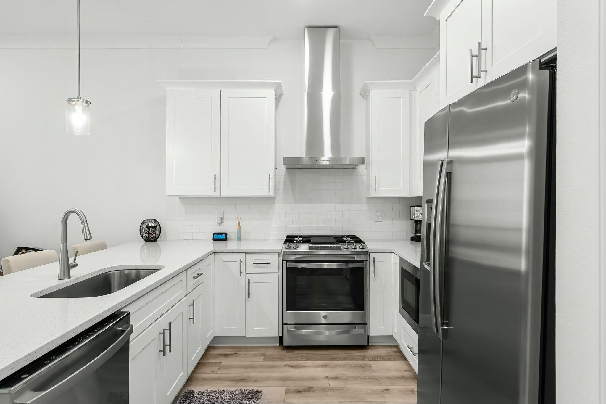 22 Kara Lake Drive Santa Rosa Beach, FL 32459 - Photo 18 of 44 a kitchen with stainless steel appliances a refrigerator sink and white cabinets