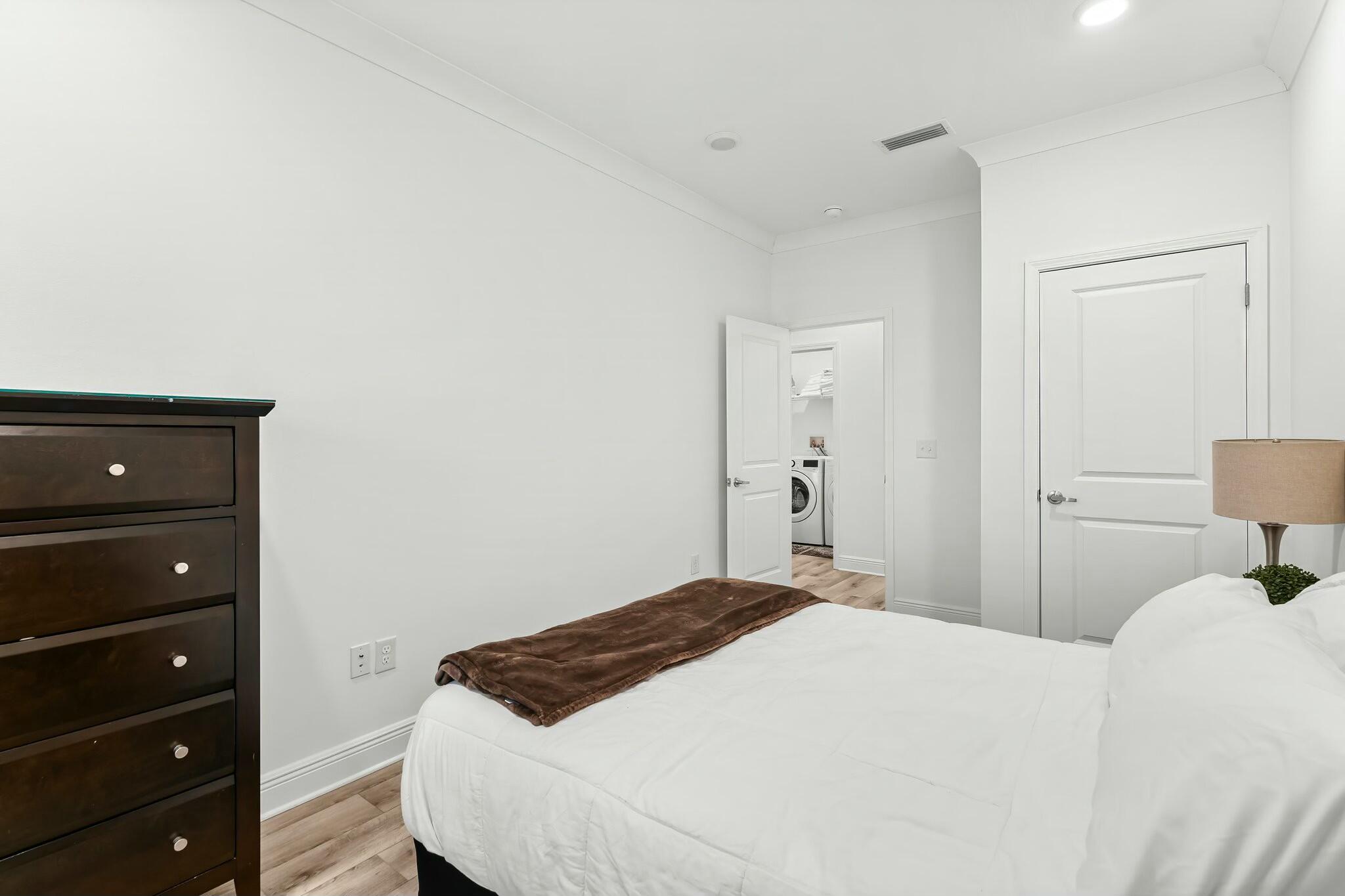 22 Kara Lake Drive Santa Rosa Beach, FL 32459 - Photo 6 of 44 a bedroom with a bed and a lamp on dresser