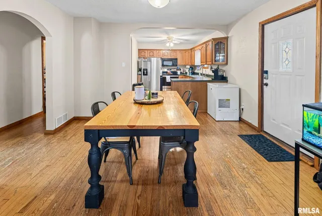 a view of a dining room with furniture and wooden floor