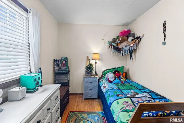 a bedroom with two beds and a potted plant
