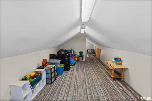 an empty room with toys and wooden floor