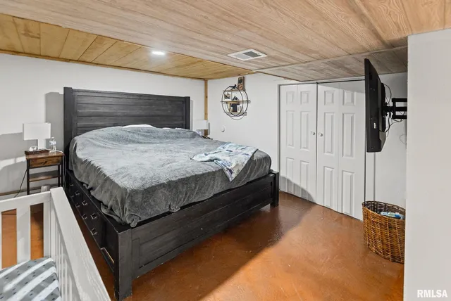 a bed sitting in a bedroom next to a window