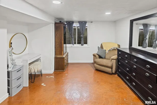 a living room with furniture a flat screen tv and a floor to ceiling window