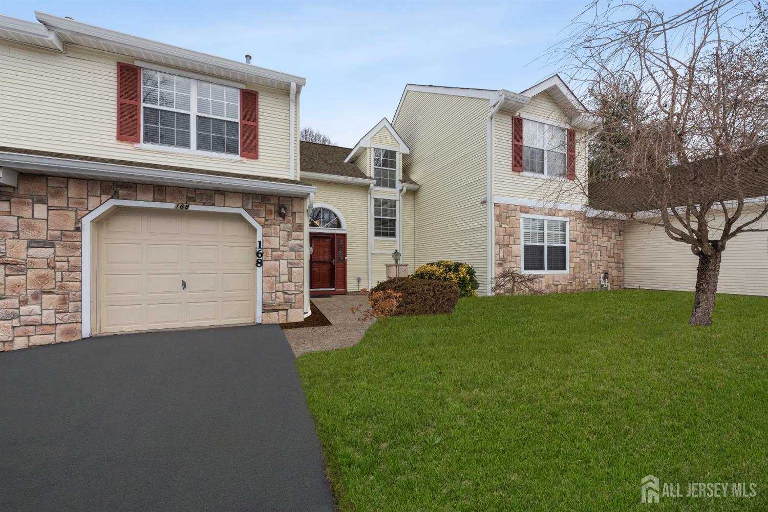 a front view of a house with a garden and garage