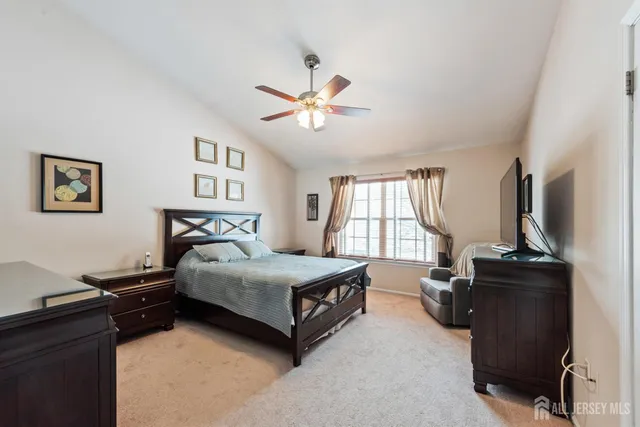 a bedroom with a bed dresser and a window