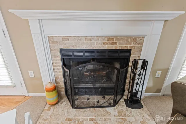 a living room with a fireplace and a table
