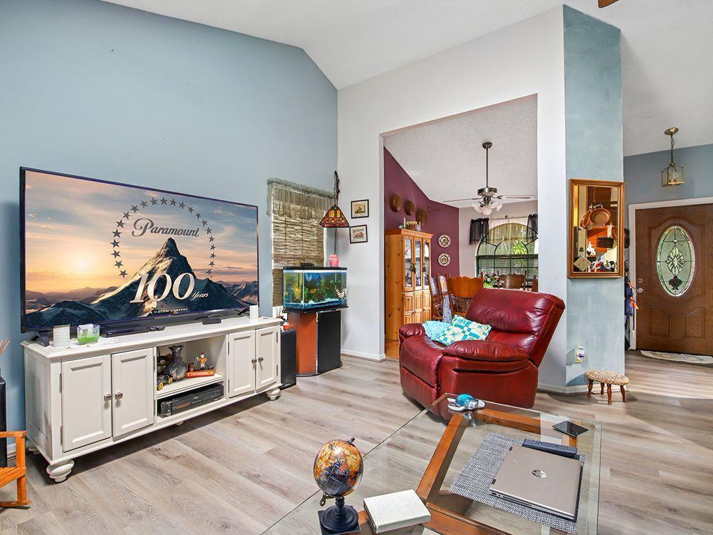 5931 Southeast Pine Drive Stuart, FL 34997 - Photo 11 of 24 a living room with furniture and a flat screen tv