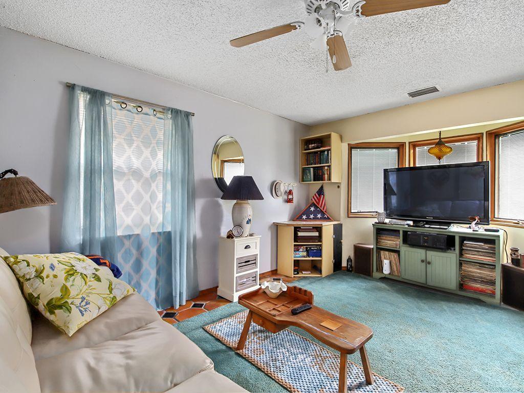 5931 Southeast Pine Drive Stuart, FL 34997 - Photo 15 of 24 a living room with furniture and a flat screen tv