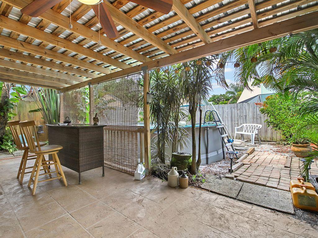 5931 Southeast Pine Drive Stuart, FL 34997 - Photo 19 of 24 a view of a chairs and table in the patio