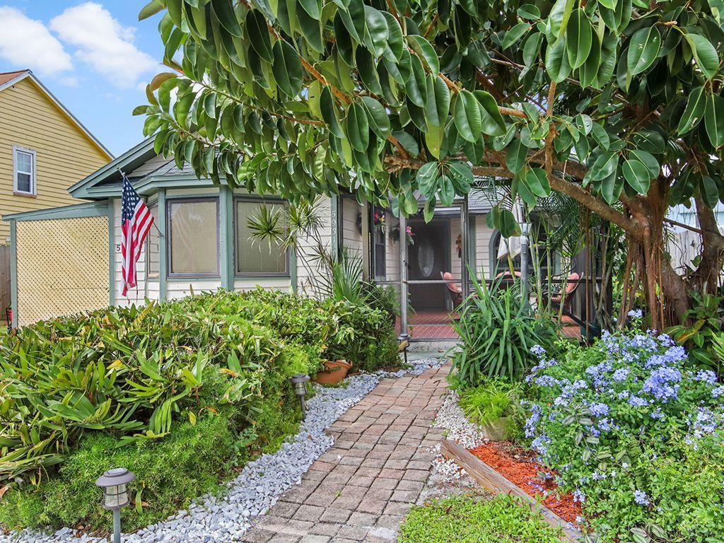 5931 Southeast Pine Drive Stuart, FL 34997 - Photo 2 of 24 a front view of a house with garden