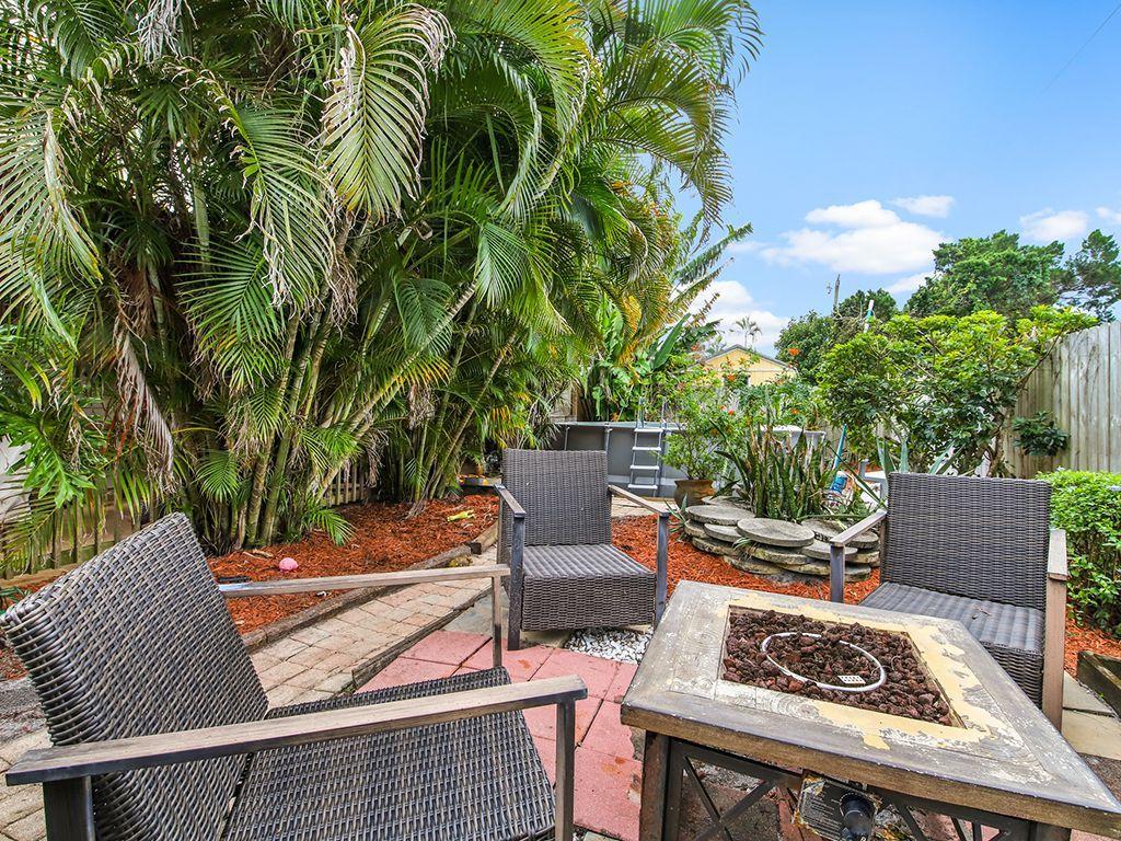 5931 Southeast Pine Drive Stuart, FL 34997 - Photo 21 of 24 a view of a patio with two chairs and a table