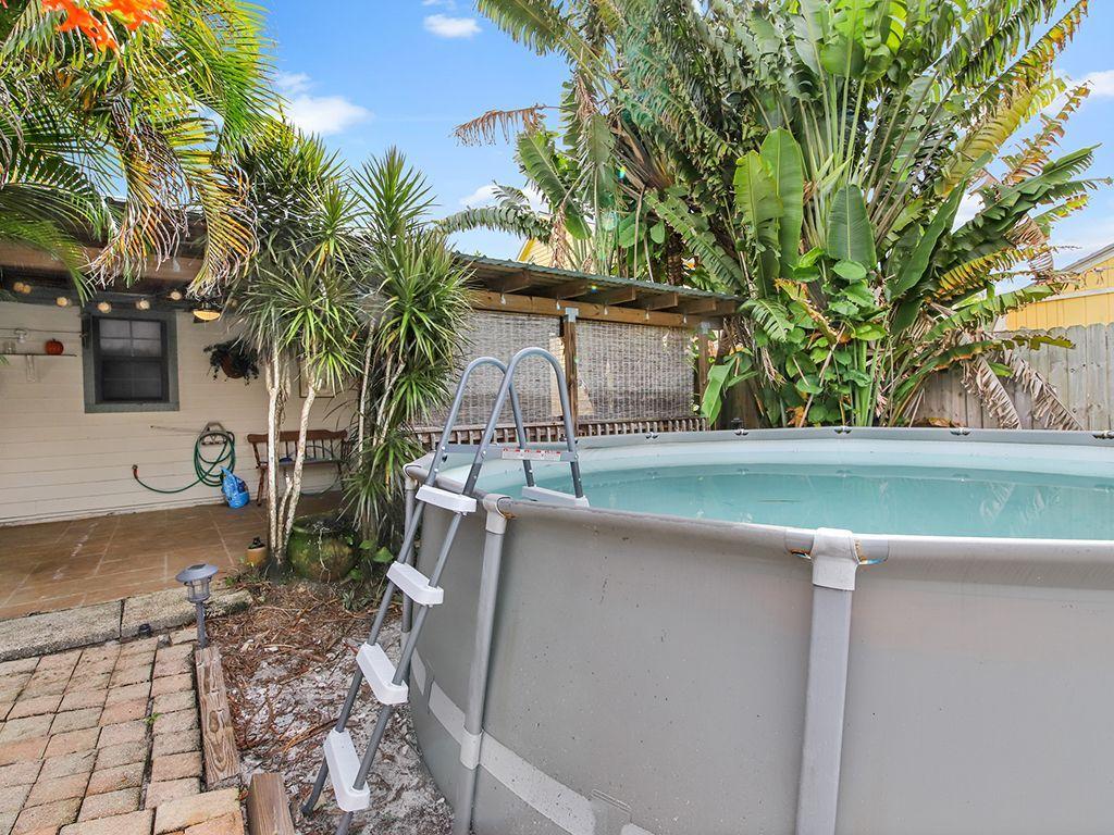 5931 Southeast Pine Drive Stuart, FL 34997 - Photo 24 of 24 a backyard of a house with seating space