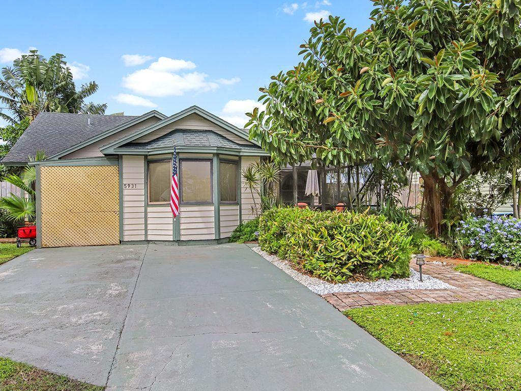 5931 Southeast Pine Drive Stuart, FL 34997 - Photo 3 of 24 a view of a house with a yard and potted plants