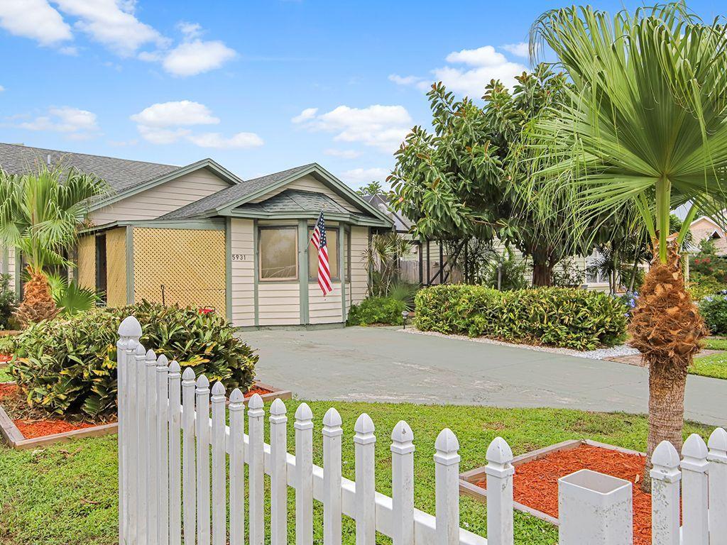 5931 Southeast Pine Drive Stuart, FL 34997 - Photo 4 of 24 a front view of a house with a garden