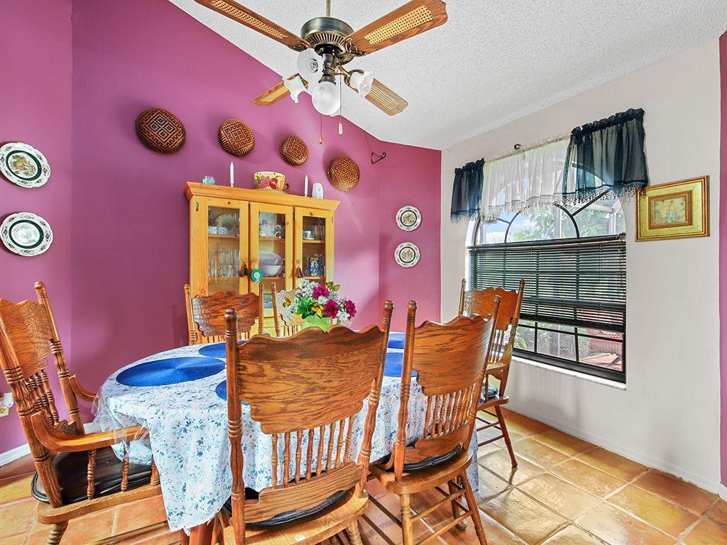5931 Southeast Pine Drive Stuart, FL 34997 - Photo 8 of 24 a view of a dining room with furniture and chandelier