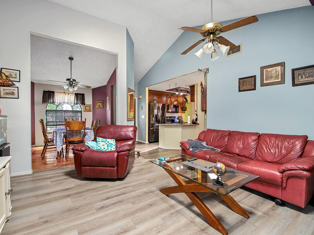 5931 Southeast Pine Drive Stuart, FL 34997 - Photo 9 of 24 a living room with furniture or couch and a flat screen tv