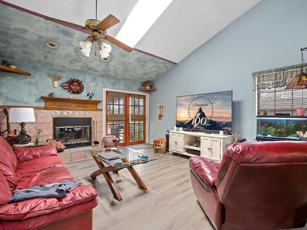 5931 Southeast Pine Drive Stuart, FL 34997 - Photo 10 of 24 a living room with furniture fireplace and flat screen tv