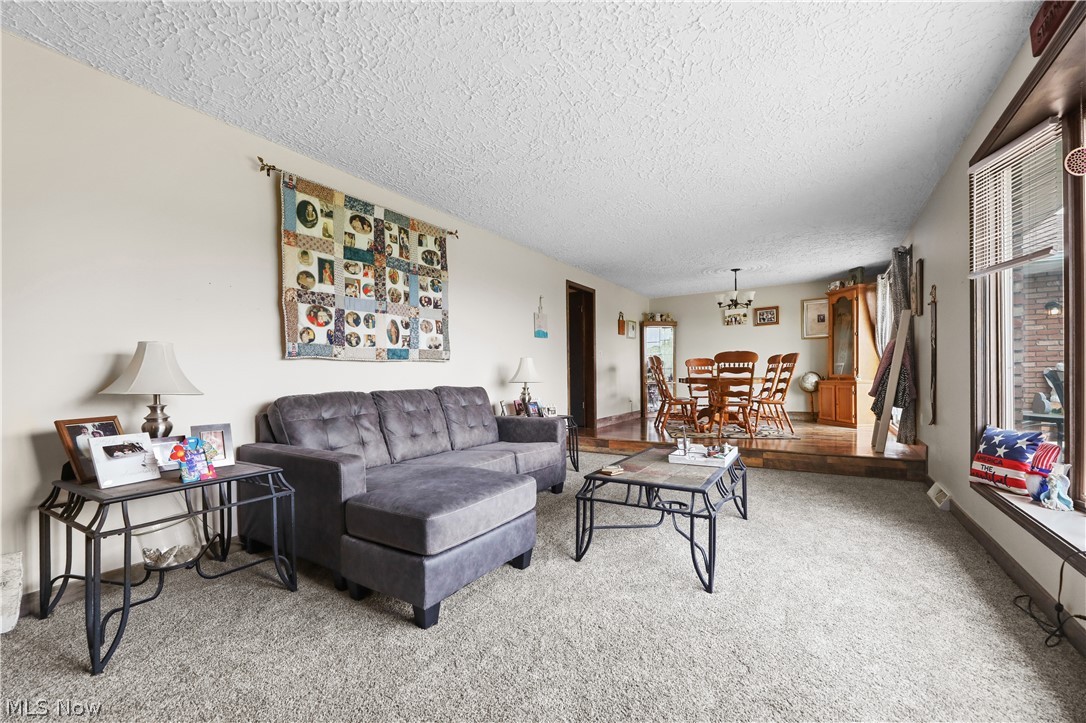 1761 May Road Mogadore, OH 44260 - Photo 2 of 10 Spacious living area with textured ceilings and light-colored walls