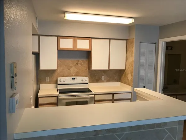 a living room with stainless steel appliances kitchen island granite countertop furniture and a window