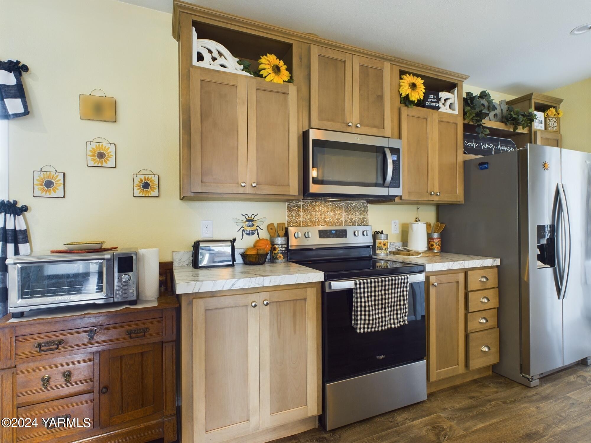 2802 South 5th Avenue, Unit 30 Union Gap, WA 98903 - Photo 8 of 27 a kitchen with stainless steel appliances granite countertop a stove a sink dishwasher and a refrigerator with wooden cabinets