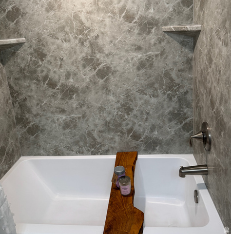 985 Springcrest Court, Unit 11 Midvale, UT 84047 - Photo 13 of 27 White bathtub with grey marbled-patterned surround and two integrated corner shelves