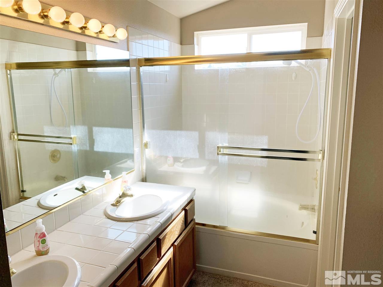 1458 Backer Way Reno, NV 89523 - Photo 15 of 25 a bathroom with a sink and mirror
