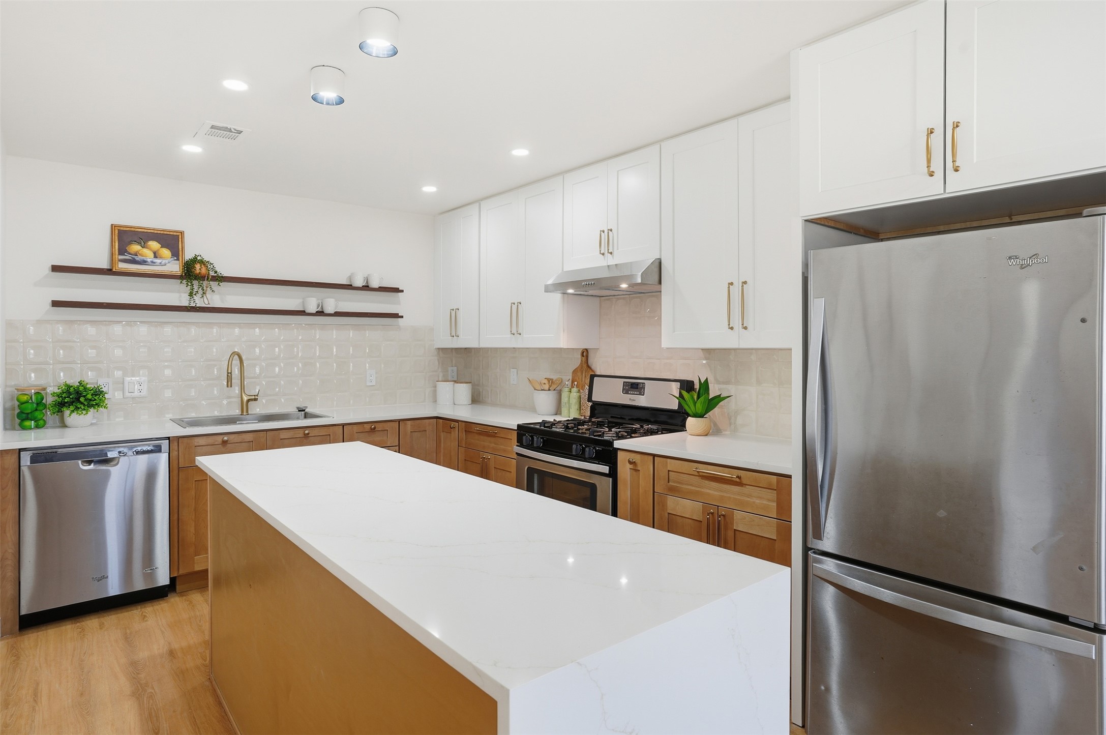 5601 Samuel Huston Avenue Austin, TX 78721 - Photo 12 of 24 Kitchen featuring stainless steel appliances, open shelves, white cabinetry, recessed lighting, and backsplash