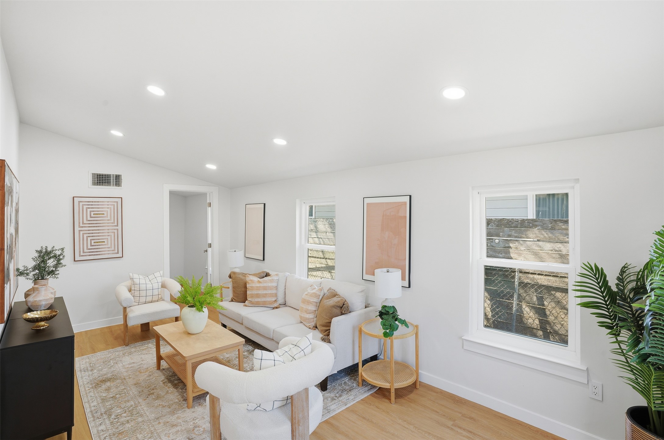 5601 Samuel Huston Avenue Austin, TX 78721 - Photo 13 of 24 Living area featuring light wood finished floors, vaulted ceiling, and recessed lighting