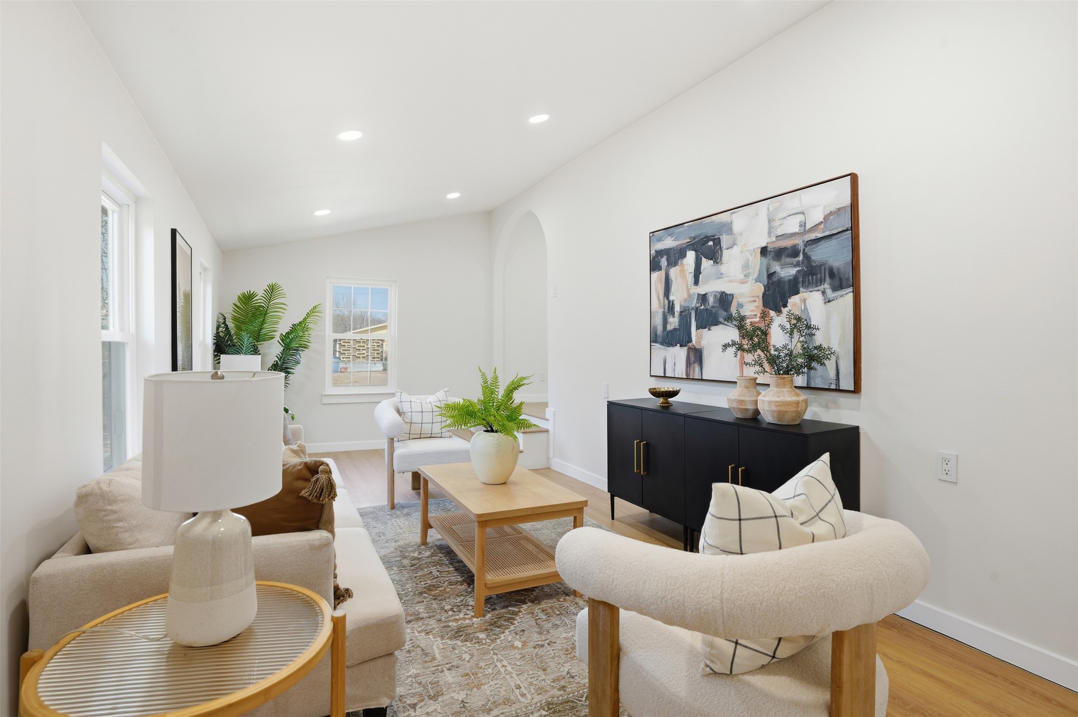 5601 Samuel Huston Avenue Austin, TX 78721 - Photo 14 of 24 Living area featuring wood finished floors, recessed lighting, arched walkways, and vaulted ceiling