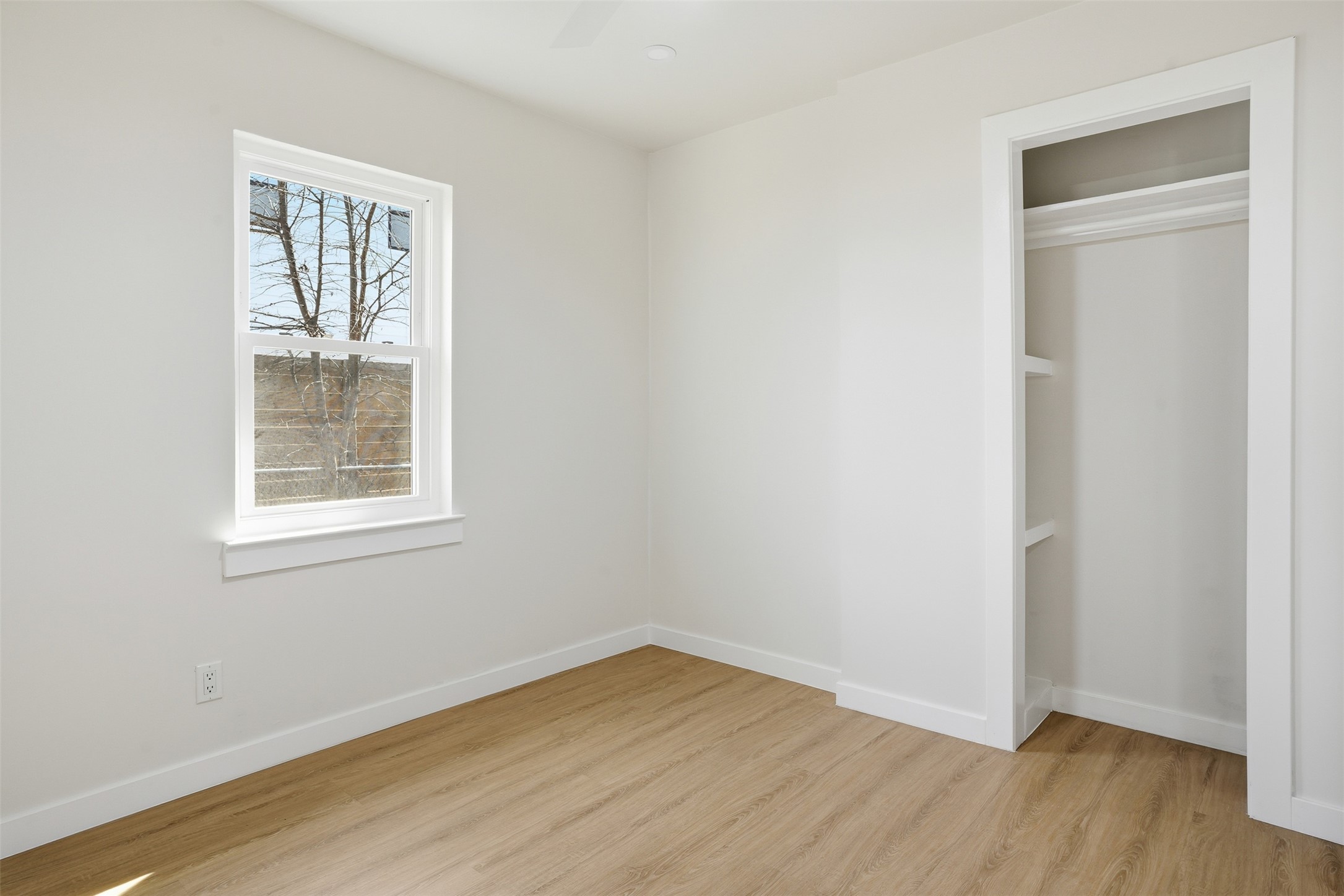 5601 Samuel Huston Avenue Austin, TX 78721 - Photo 15 of 24 Unfurnished bedroom featuring light wood finished floors and a closet