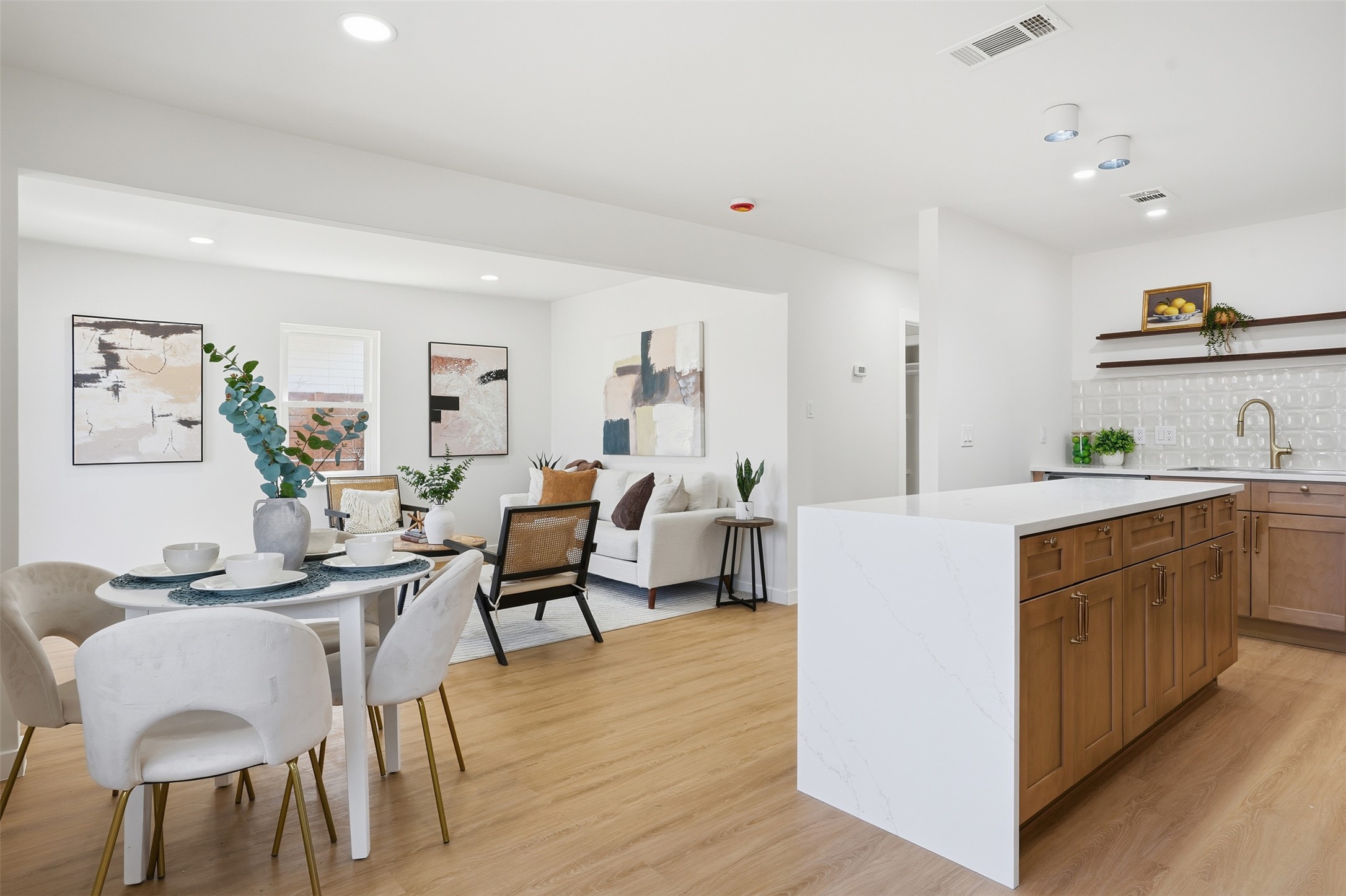 5601 Samuel Huston Avenue Austin, TX 78721 - Photo 5 of 24 Kitchen with wood finish cabinets, light wood finished floors, open shelves, tasteful backsplash, and light stone counters