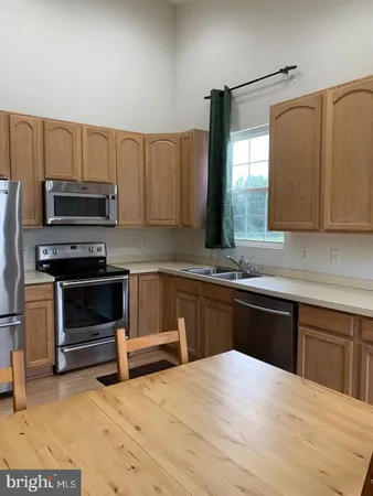 a kitchen with a cabinets appliances and a sink