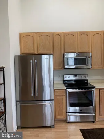 a kitchen with a refrigerator stove and microwave